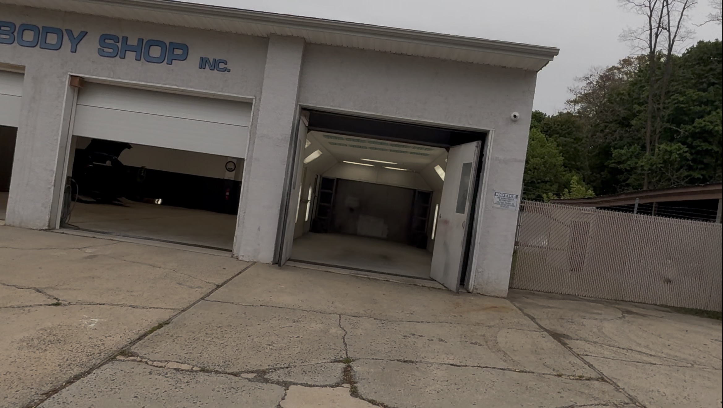AURA G-MAN Collision Center exterior with service bays open