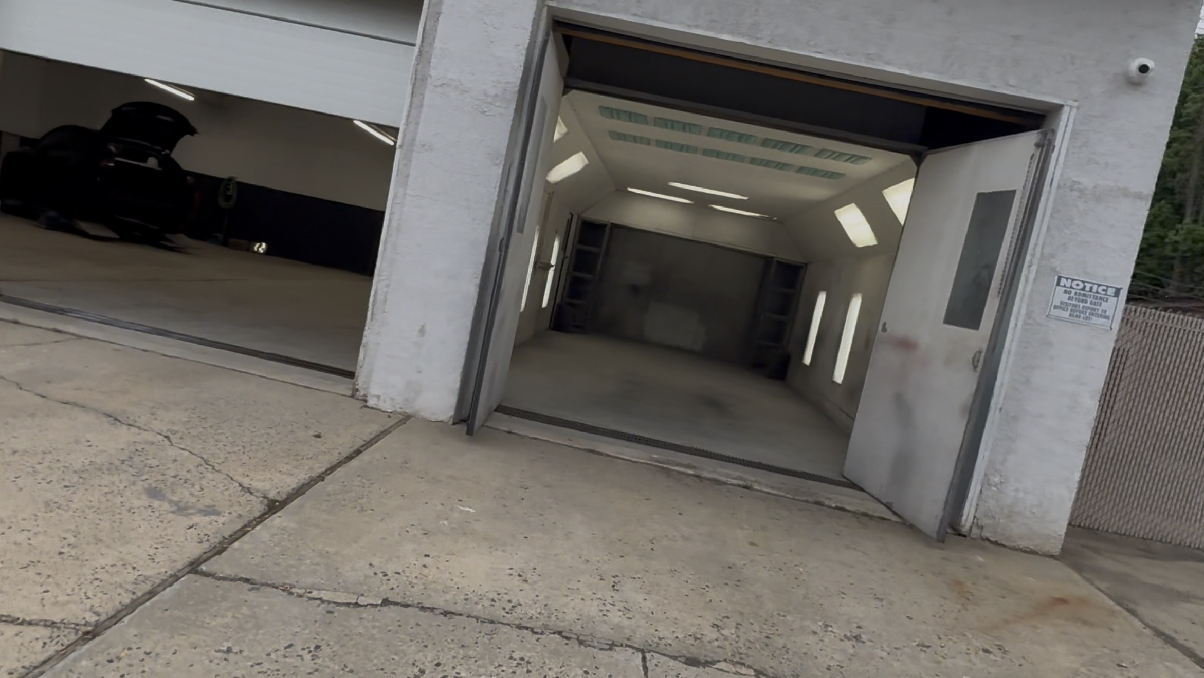 Spacious interior work bay with vehicle on lift