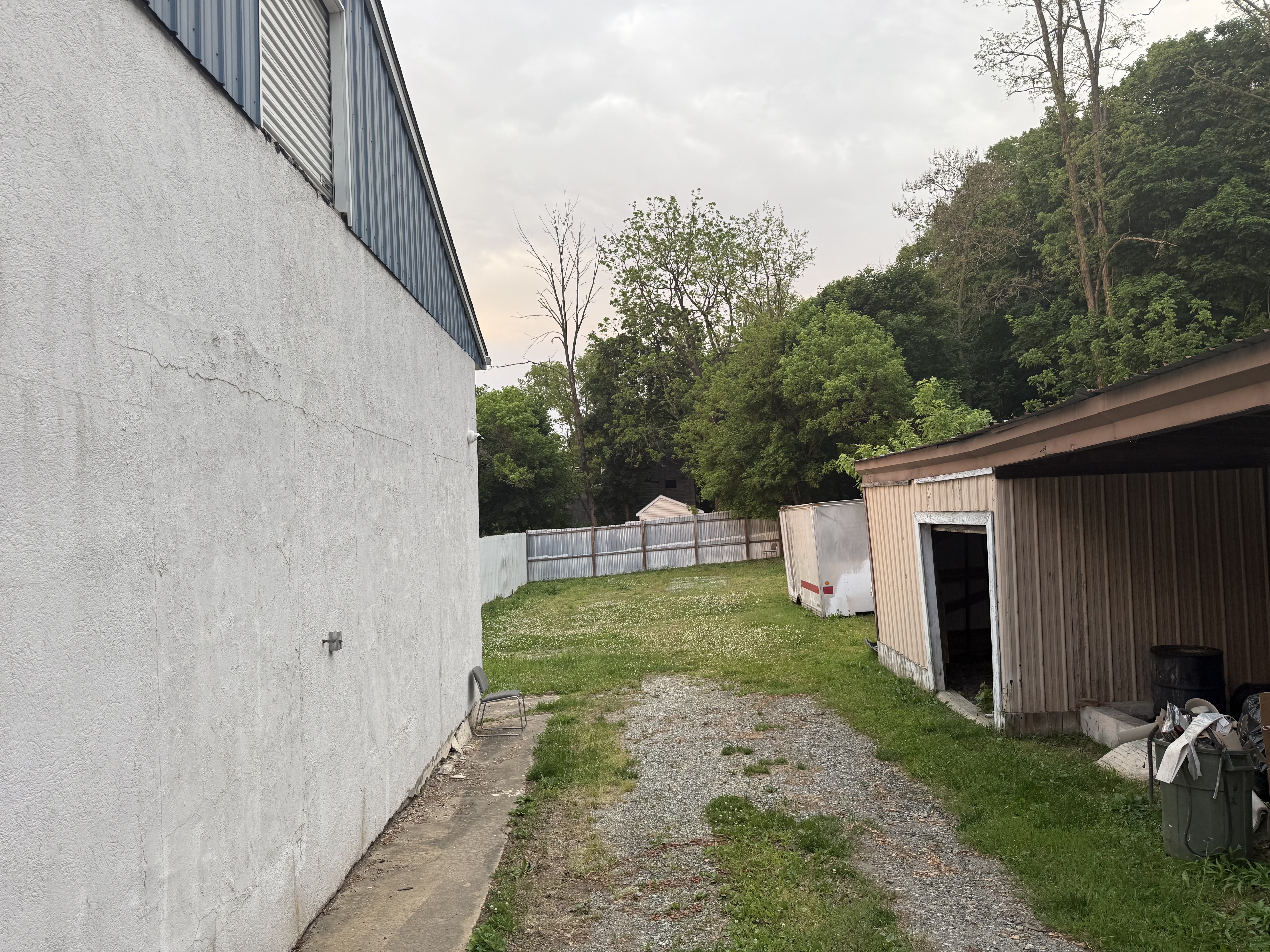 Rear property view showing storage shed and yard space