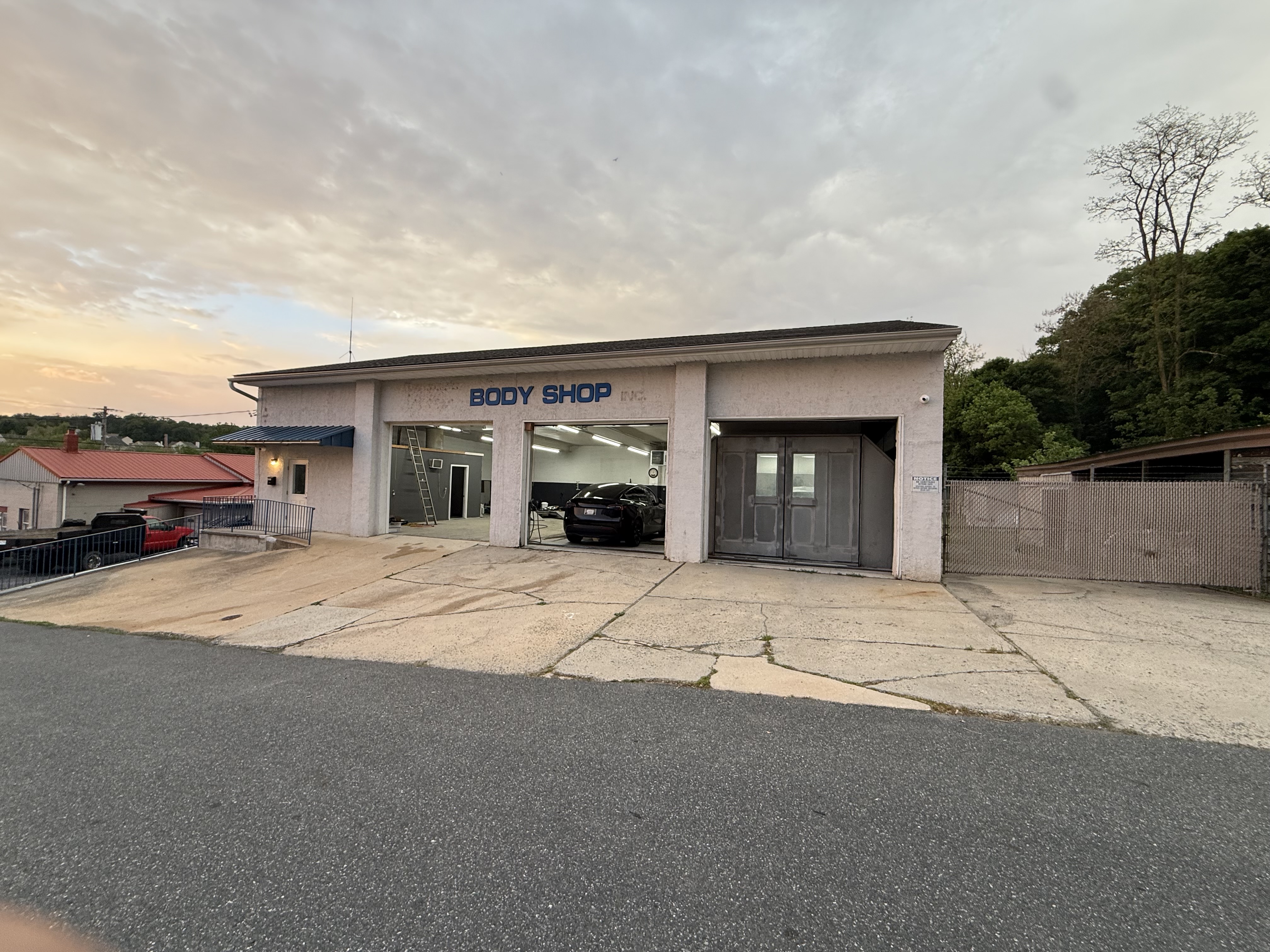 AURA G-MAN body shop exterior with car visible inside service bay