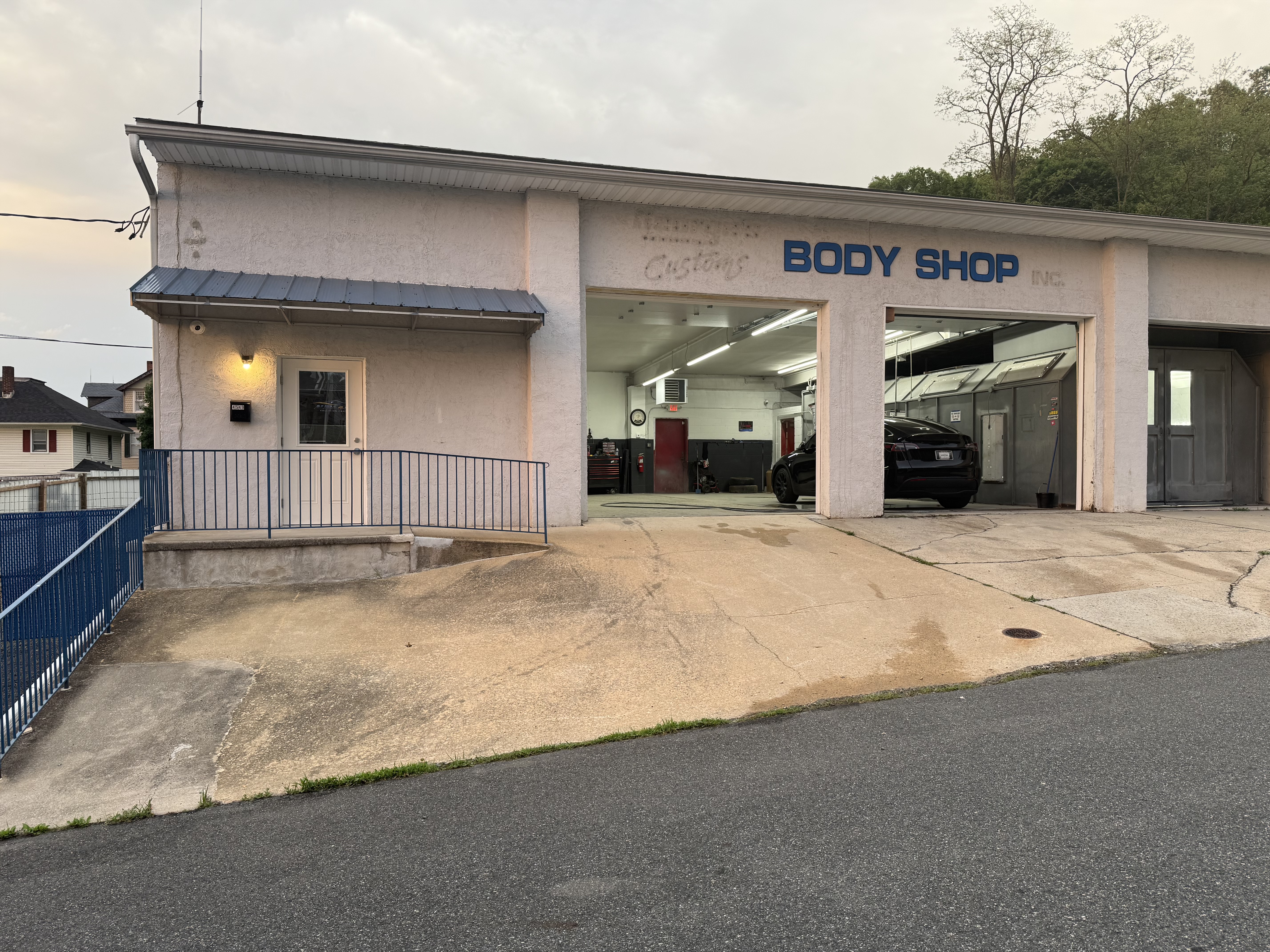 Full facility view showing office entrance and multiple service bays